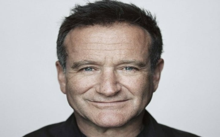 Thomas E. van Dell smiling in a black shirt.